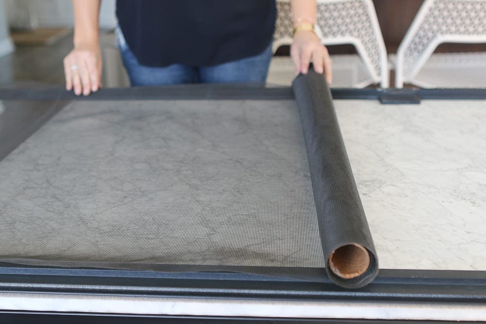 New custom window screen installed on residential window for improved airflow and protection